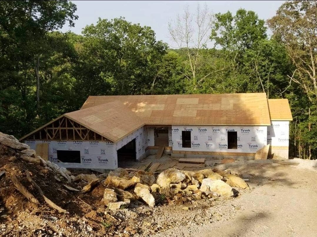 A house that is being built in the dirt.